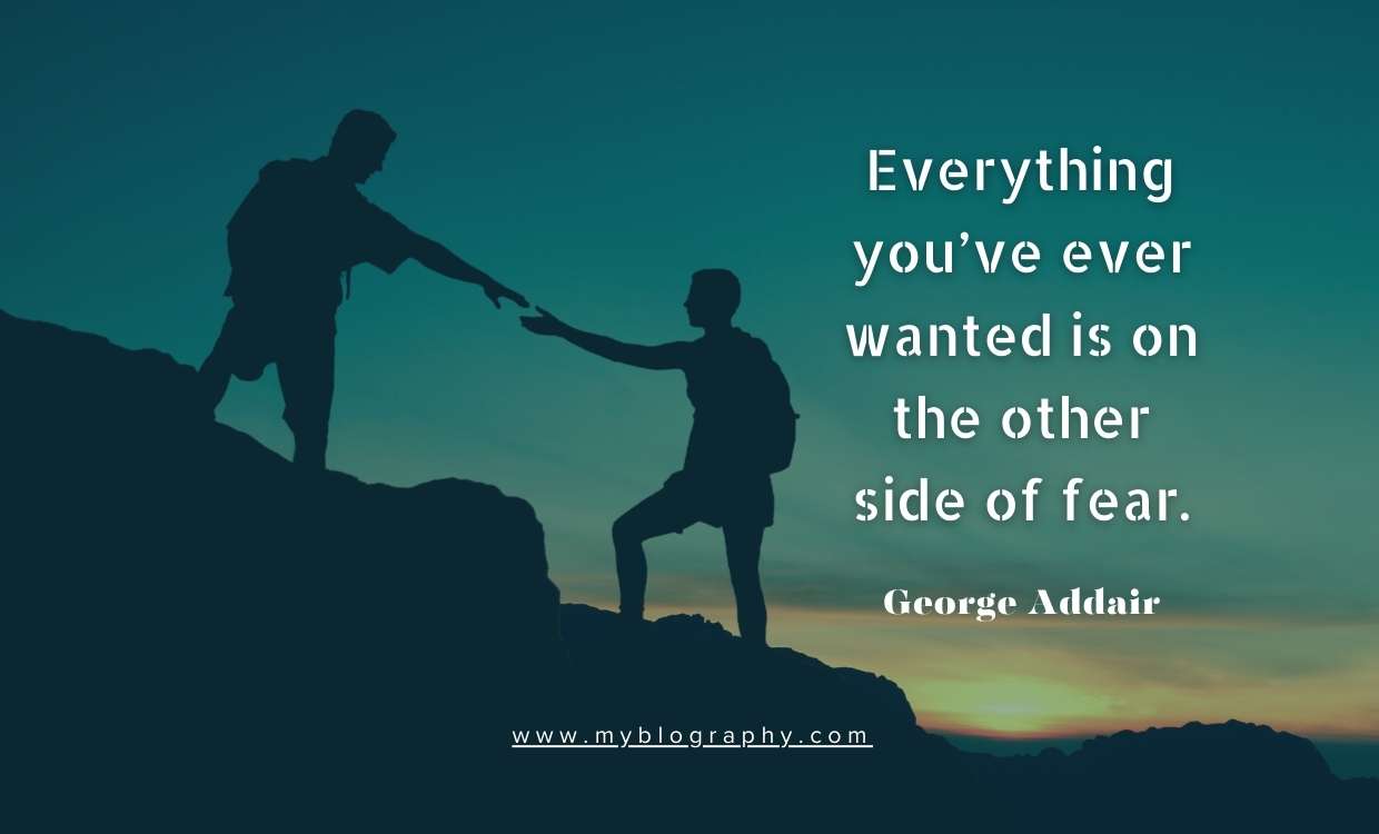 A person standing on hieght giving hand to pull up other person, symbolizing moving past fear to reach goals.
